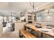 Open-concept dining area adjoining the kitchen, featuring a wooden table, bench, and a modern chandelier at 1630 Egret Way, Superior, CO 80027