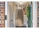 View of an entryway featuring a stairway with carpeted steps, a tiled floor, and a decorative green front door at 1630 Egret Way, Superior, CO 80027