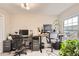 Bright home office featuring two workstations with adjustable desks and a large window at 1630 Egret Way, Superior, CO 80027