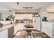 Well-lit kitchen with white cabinets, stainless steel appliances, granite counters, and a portable island at 1630 Egret Way, Superior, CO 80027