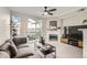 Cozy living room with a fireplace, sliding glass doors to the balcony, and a comfortable couch at 1630 Egret Way, Superior, CO 80027