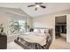 Bright main bedroom with vaulted ceilings, ceiling fan, ensuite, and lots of natural light from the large window at 1630 Egret Way, Superior, CO 80027