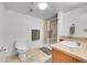 Bathroom featuring a glass-enclosed shower, tile flooring, and a sink with ample counter space at 7077 S Bryant St, Littleton, CO 80120