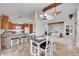 Open concept dining room with a chandelier, high ceilings, and bar seating to the kitchen with stainless steel appliances at 7077 S Bryant St, Littleton, CO 80120