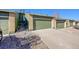 Attached garage with a long driveway and stone landscaping and table with chairs at 7077 S Bryant St, Littleton, CO 80120