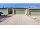 Attached garage with a long driveway and stone landscaping at 7077 S Bryant St, Littleton, CO 80120