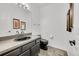 Stylish half bathroom with a black toilet, vanity, and decorative mirror at 7077 S Bryant St, Littleton, CO 80120