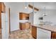 Kitchen featuring wood cabinets, ample counter space, and modern appliances at 7077 S Bryant St, Littleton, CO 80120