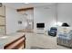 Open-concept living room with high ceilings, a ceiling fan, and a stone fireplace at 7077 S Bryant St, Littleton, CO 80120