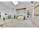 Bright living room with skylight, a stone fireplace and adjacent loft area at 7077 S Bryant St, Littleton, CO 80120