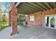 Covered back patio with a small table set and brick supports at 16627 W 1St Ave, Golden, CO 80401
