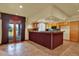 Basement bar area with lots of storage, a pass-through window, and tile flooring at 16627 W 1St Ave, Golden, CO 80401