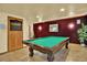 Basement with a pool table, decorated wall, and door with TV above at 16627 W 1St Ave, Golden, CO 80401