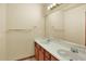 Bright bathroom featuring a dual sink vanity and a large mirror at 16627 W 1St Ave, Golden, CO 80401