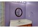 Bathroom featuring a round mirror, modern lighting, and a stylish sink at 16627 W 1St Ave, Golden, CO 80401