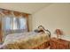 Cozy bedroom with a comfortable bed, a side table with lamp, and window at 16627 W 1St Ave, Golden, CO 80401