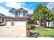 Charming two-story home with well-maintained lawn, a large shade tree and three-car garage at 16627 W 1St Ave, Golden, CO 80401