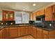 Kitchen featuring wood cabinetry, granite counters, and a gas cooktop stove at 16627 W 1St Ave, Golden, CO 80401