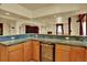 Spacious kitchen area featuring granite countertops, wood cabinets, and a wine fridge at 16627 W 1St Ave, Golden, CO 80401