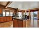 Kitchen with hardwood floors, marble countertops, and grand chandelier, with open doorway to the patio at 16627 W 1St Ave, Golden, CO 80401