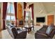 Living room with stone fireplace, large windows, flat screen television, and leather seating at 16627 W 1St Ave, Golden, CO 80401