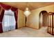 Room with a ceiling that has a dark-toned paint and ornate chandelier plus a window and decorative valance at 16627 W 1St Ave, Golden, CO 80401
