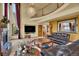 Living room with fireplace, flat screen TV, comfortable leather couches, and grand chandelier at 16627 W 1St Ave, Golden, CO 80401