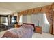 Primary bedroom with elegant window treatments, fireplace, and relaxing ambiance at 16627 W 1St Ave, Golden, CO 80401