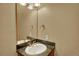 Powder room featuring stylish mirror, vanity, granite counters, and designer fixtures at 16627 W 1St Ave, Golden, CO 80401