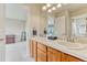 Bathroom with dual sinks, wood cabinets, and an attached toilet room, offering functionality and style at 1127 Buttermilk Rd, Larkspur, CO 80118