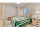 Cozy bedroom features a queen-sized bed, side tables with lamps, and a window with natural light at 1127 Buttermilk Rd, Larkspur, CO 80118