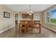 Dining room with a built-in cabinet, window, hardwood floors, and stylish chandelier at 1127 Buttermilk Rd, Larkspur, CO 80118