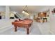 Entertaining game room featuring a pool table, kitchenette, and easy access to the staircase at 1127 Buttermilk Rd, Larkspur, CO 80118