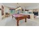 Bright game room features pool table, neutral walls, and bright windows with outdoor views at 1127 Buttermilk Rd, Larkspur, CO 80118