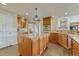 Kitchen featuring a large island, hardwood floors, and built in appliances at 1127 Buttermilk Rd, Larkspur, CO 80118