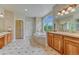 Large main bathroom with dual sink vanity, soaking tub, and lots of natural light at 1127 Buttermilk Rd, Larkspur, CO 80118