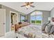 Inviting main bedroom featuring ensuite bathroom, comfortable furnishings, and a window with scenic views at 1127 Buttermilk Rd, Larkspur, CO 80118