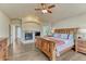 Well lit main bedroom with a fireplace and wood floors at 1127 Buttermilk Rd, Larkspur, CO 80118