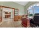 Office with hardwood floors and large window with a dining room view at 1127 Buttermilk Rd, Larkspur, CO 80118
