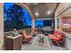 Cozy covered patio with comfortable seating, a grill, and views of the surrounding landscape at 1127 Buttermilk Rd, Larkspur, CO 80118