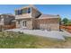 Charming backyard with large patio, stone accents, green grass, and cozy seating at 24738 E Layton Pl, Aurora, CO 80016