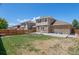 Spacious backyard featuring a large concrete patio, green grass, and stone accents at 24738 E Layton Pl, Aurora, CO 80016