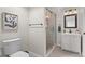 Modern bathroom with stylish vanity, framed mirror, and glass-enclosed shower at 24738 E Layton Pl, Aurora, CO 80016