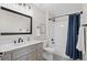 Bathroom featuring gray vanity, black fixtures and a tub and shower combination at 24738 E Layton Pl, Aurora, CO 80016