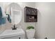 Small bathroom featuring sink with decorative cabinet and dark cabinet above toilet at 24738 E Layton Pl, Aurora, CO 80016