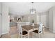Open floor plan featuring dining area with decorative light fixture and view of kitchen at 24738 E Layton Pl, Aurora, CO 80016
