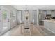 Bright dining area features gray cabinets, stainless steel refrigerator, wood table and seating for four at 24738 E Layton Pl, Aurora, CO 80016