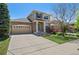 Beautiful two-story home with stone detailing, attached two car garage, and a well-maintained lawn at 24738 E Layton Pl, Aurora, CO 80016