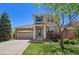 Charming two-story home with stone accents, a well-manicured lawn, and a neatly landscaped front yard at 24738 E Layton Pl, Aurora, CO 80016