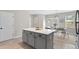 Kitchen island with white countertop and gray cabinets and a view of the dining area at 24738 E Layton Pl, Aurora, CO 80016